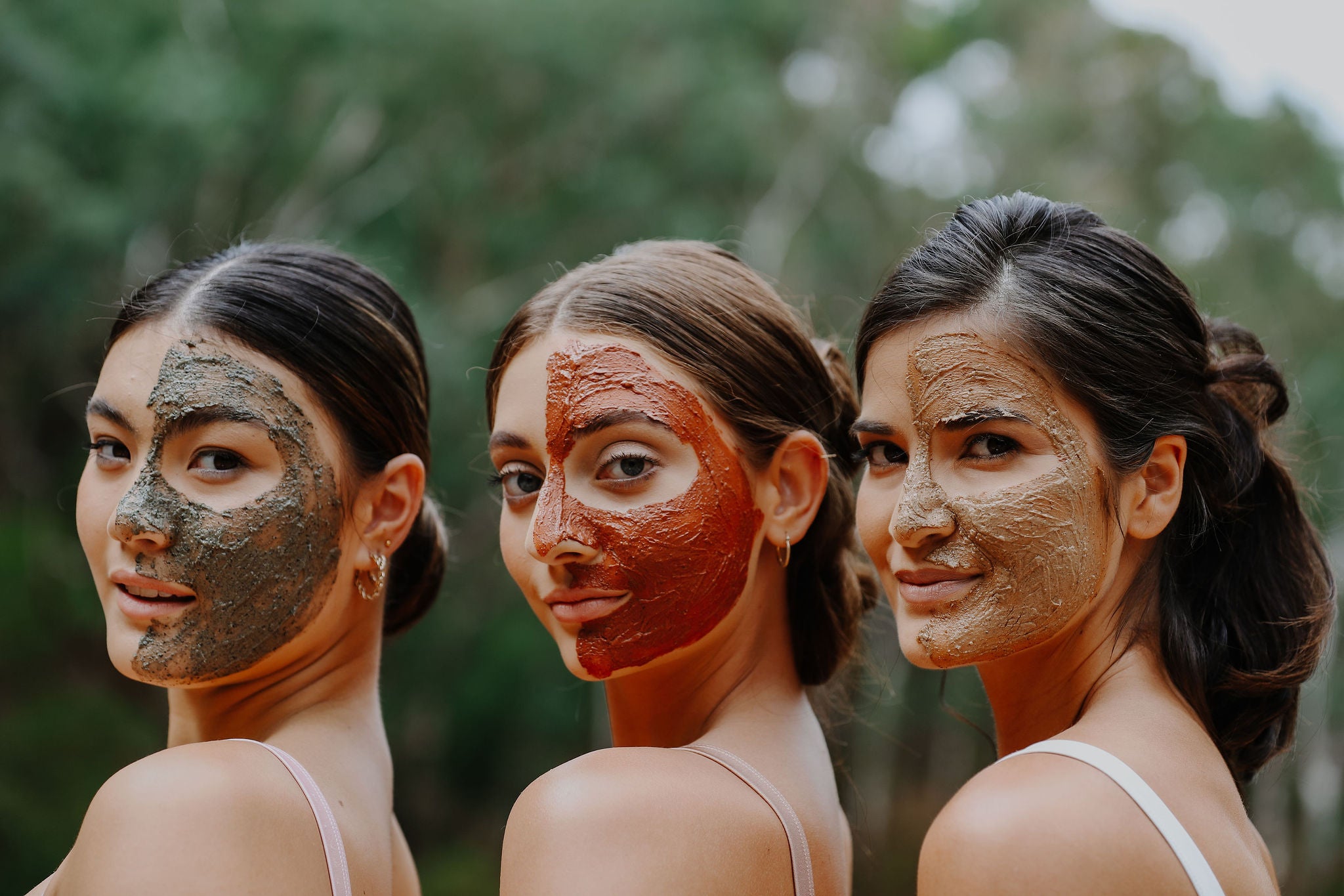 three models with wild fusion skincare 2 in 1 mask on one side of their faces.