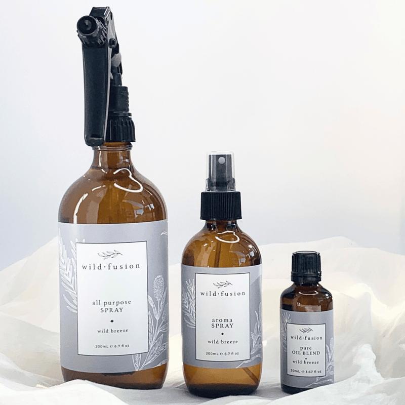 A line up of the Wild Breeze all purpose spray, aroma spray and pure oil blend concentrate. Lemongrass, tea tree, myrtle, citronella, lavender and rosemary essential oils. White background and soft material. Wild Fusion Skincare