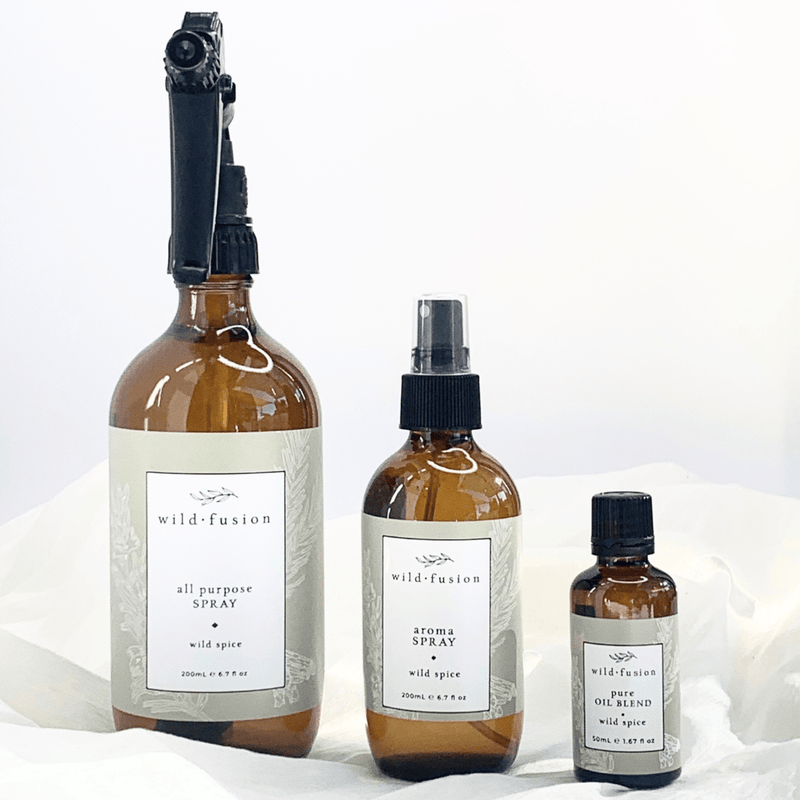 A line up of the Wild Breeze all purpose spray, aroma spray and pure oil blend concentrate. Eucalyptus, lemon, rosemary, cinnamon bark and clove essential oils. White background and soft material. Wild Fusion Skincare